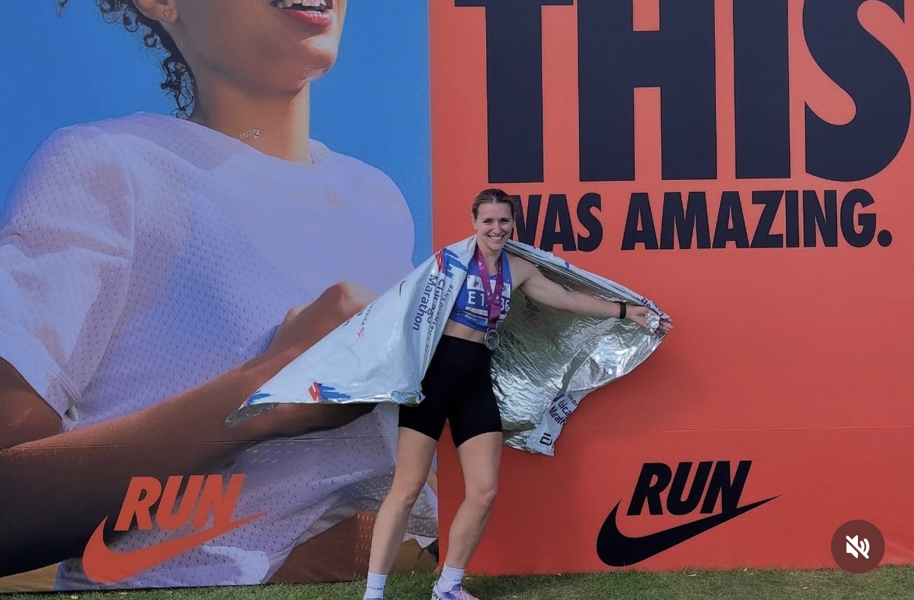 Sierra Morris at the Chicago Marathon finish in front of the Nike finish-line wall